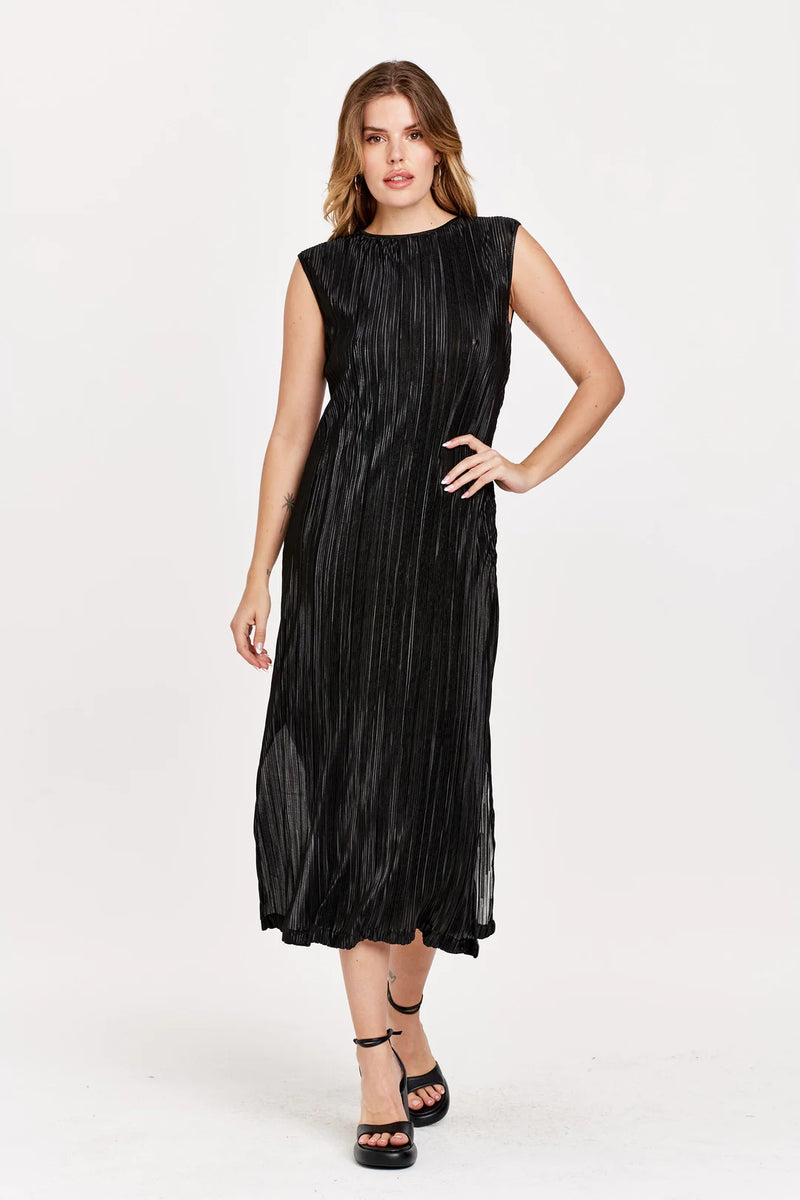 Woman wearing textured, sleeveless black dress with side slit