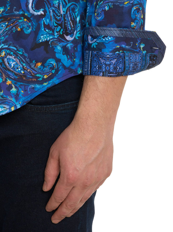 Man wearing long sleeve button down dress shirt with blue background and vibrant blue paisley print