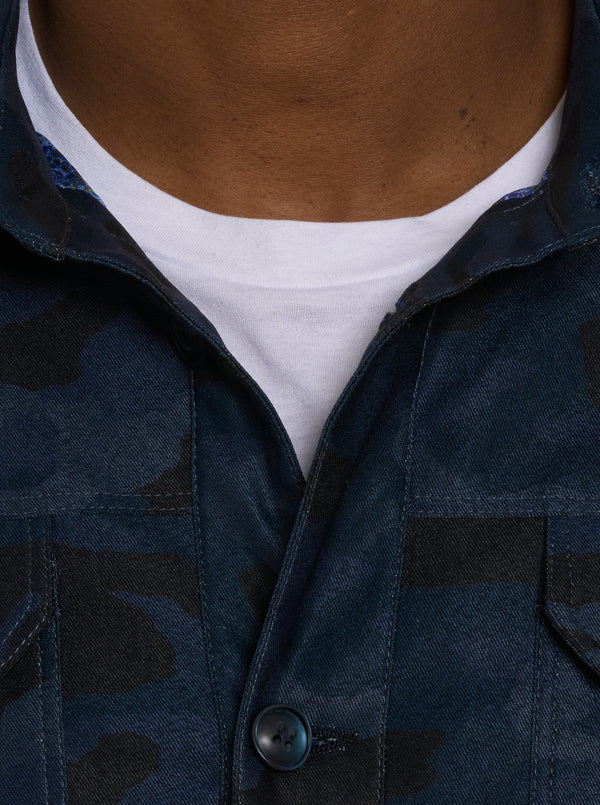 Man wearing blue and black camo shirt jacket with button front and double breast pockets