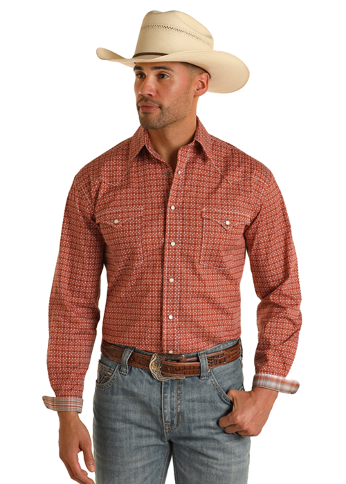 Man wearing long sleeve orange button up shirt with double breast pockets in a geometric pattern