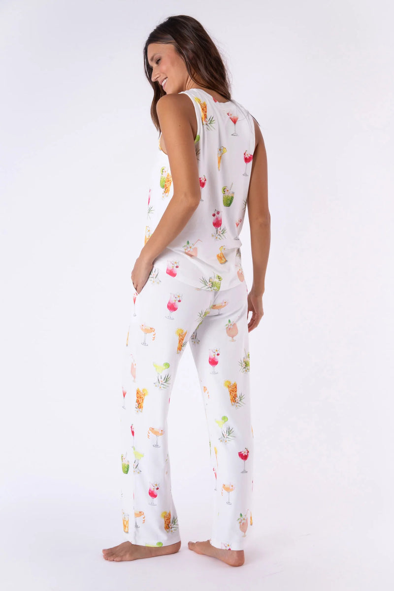 Woman wearing pajama pants with white background and vibrant cocktails throughout
