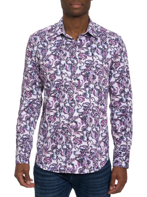 Man wearing long sleeve button down dress shirt with white background with purple, blue and black ornate pattern adorned with floral print all over