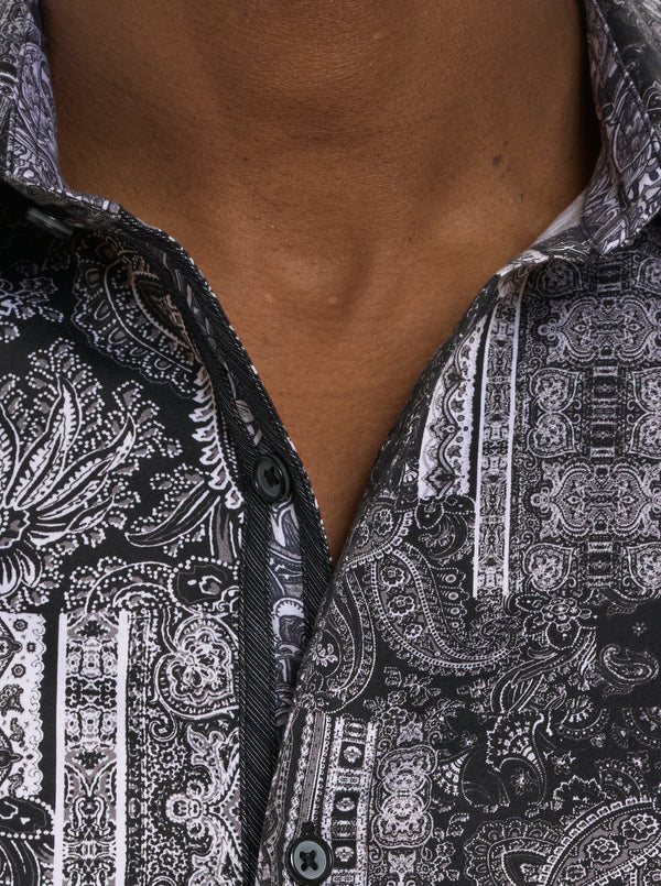 Man wearing black and white paisley button down shirt 