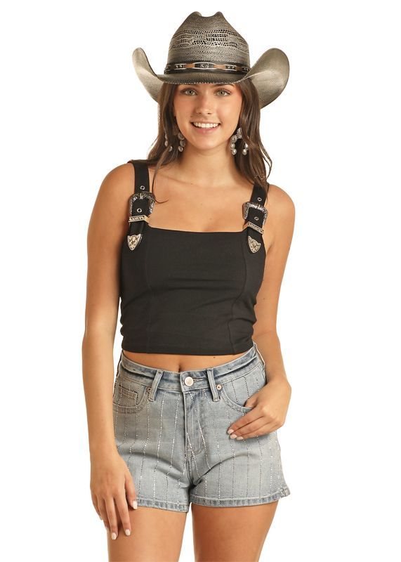 Woman wearing square neckline black tank top with metal western buckles on the front of the straps