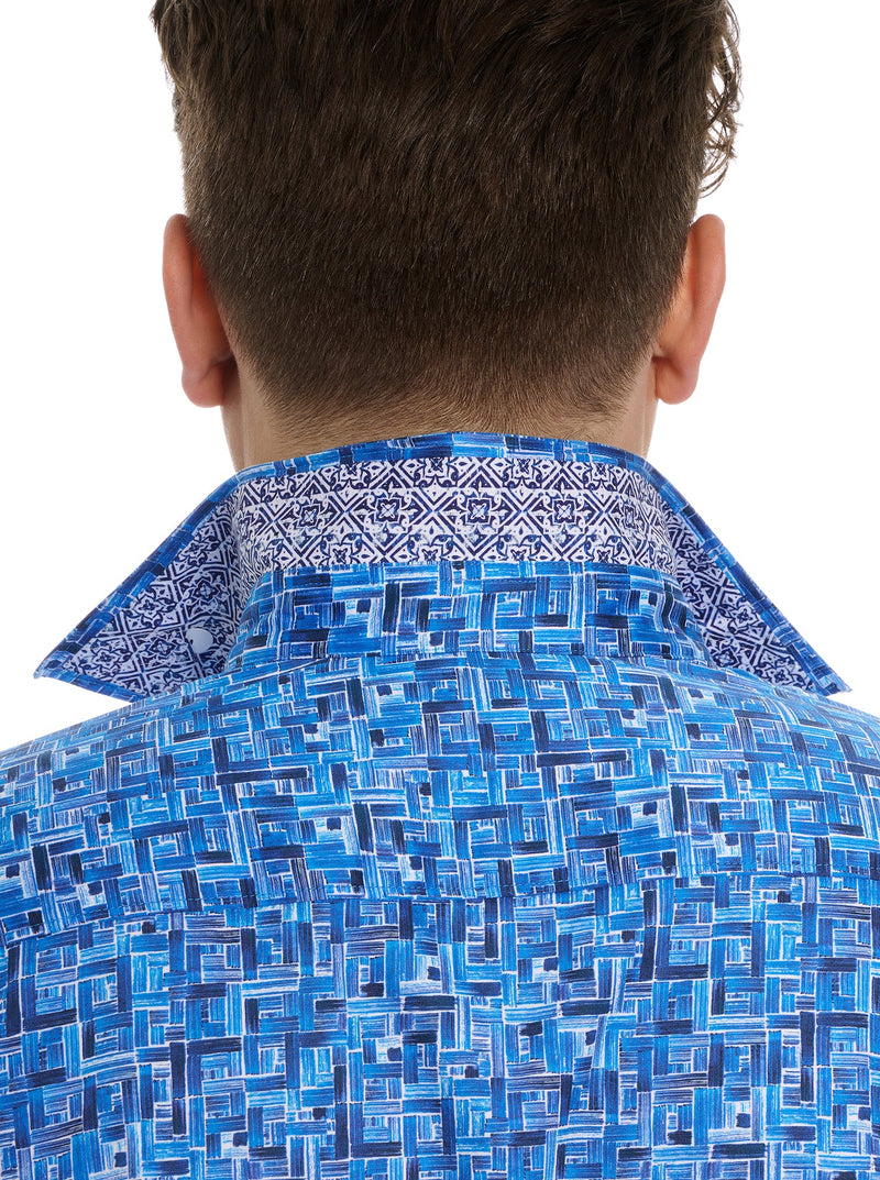 Man wearing long sleeve dress shirt with blue square pattern throughout