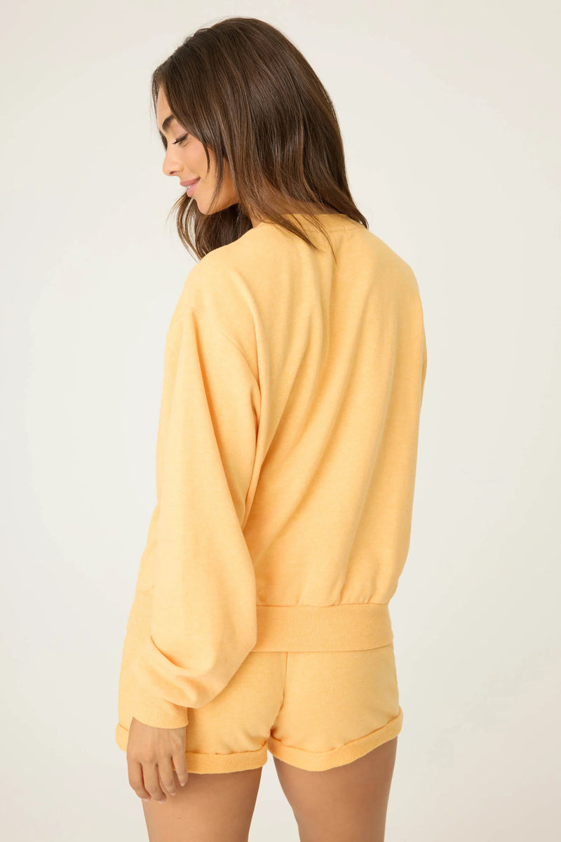 Woman wearing a yellow outfit against a plain background