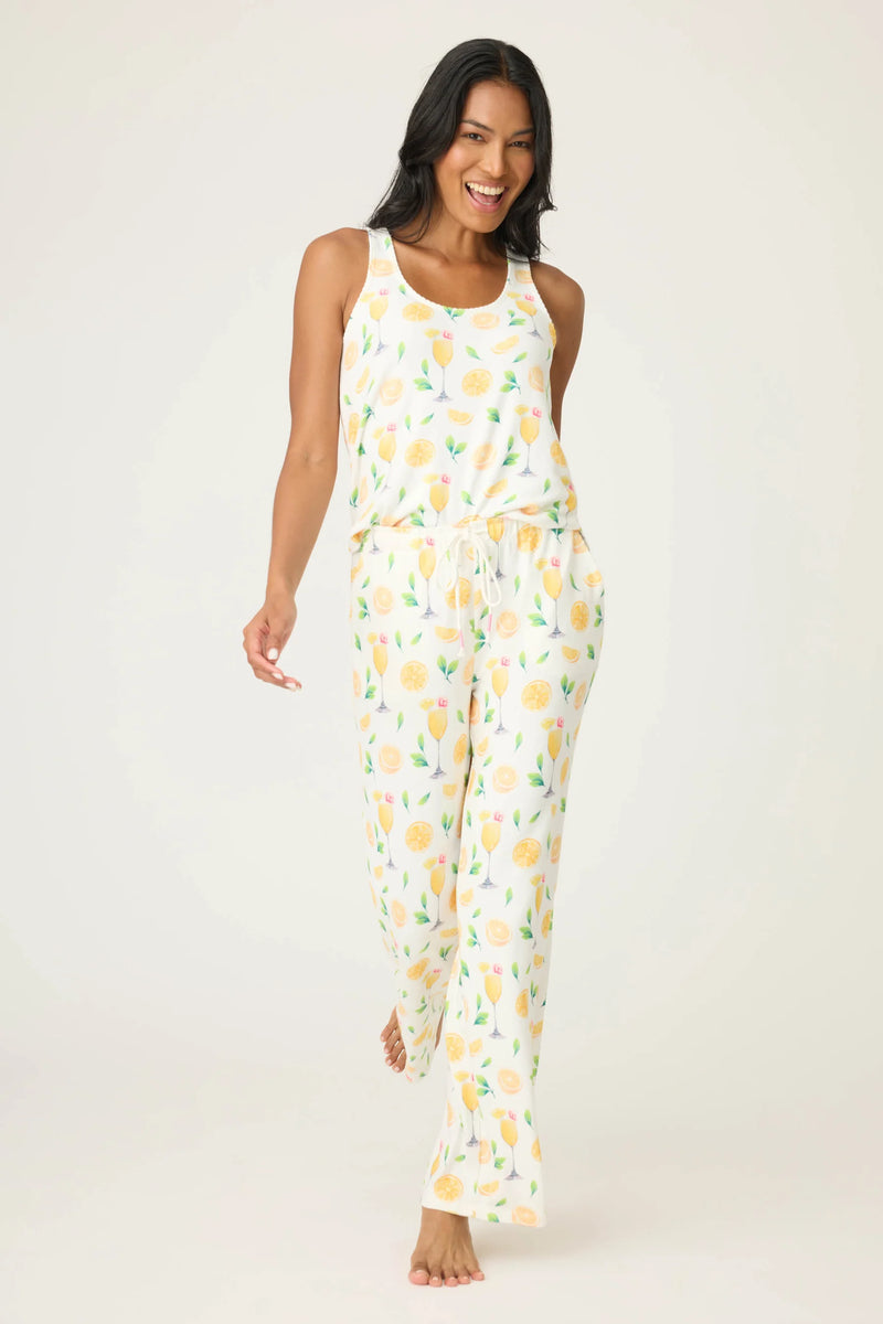 Woman wearing a lemon-patterned pajama set on a white background
