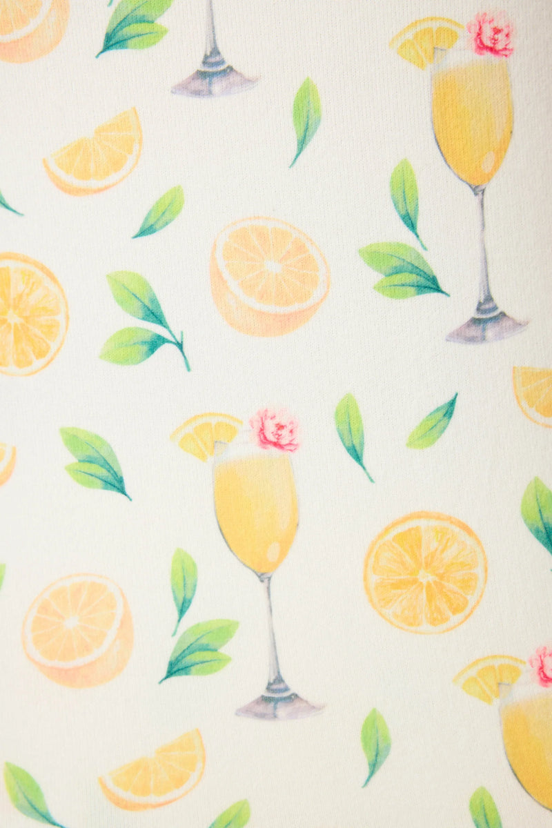 Pattern of lemon slices, cocktail glasses, and leaves on a light background