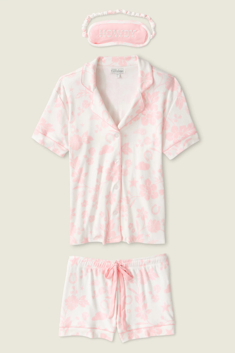 Pink tie-dye pajama set with matching eye mask on a light beige background