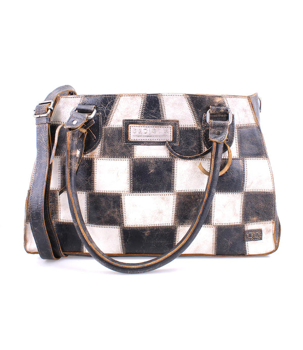Black and white leather checker print purse with handle attached and cross body feature