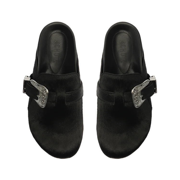 Clog style shoe with black cowhide exterior and silver western buckle with matching tip on the side