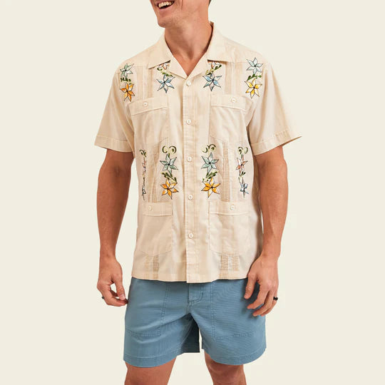 Short sleeve Hawaiian guayabera shirt with four pockets on the front with flowers in blue and orange flowers throughout