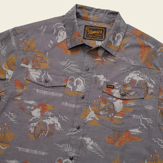 Grey short sleeve shirt with images of cow skill, canyon, wagon wheel and cacti in orange, yellow and hazel colorway