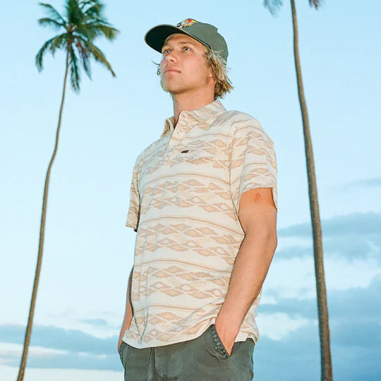 Tan polo shirt with darker tan and orange tribal pattern all over