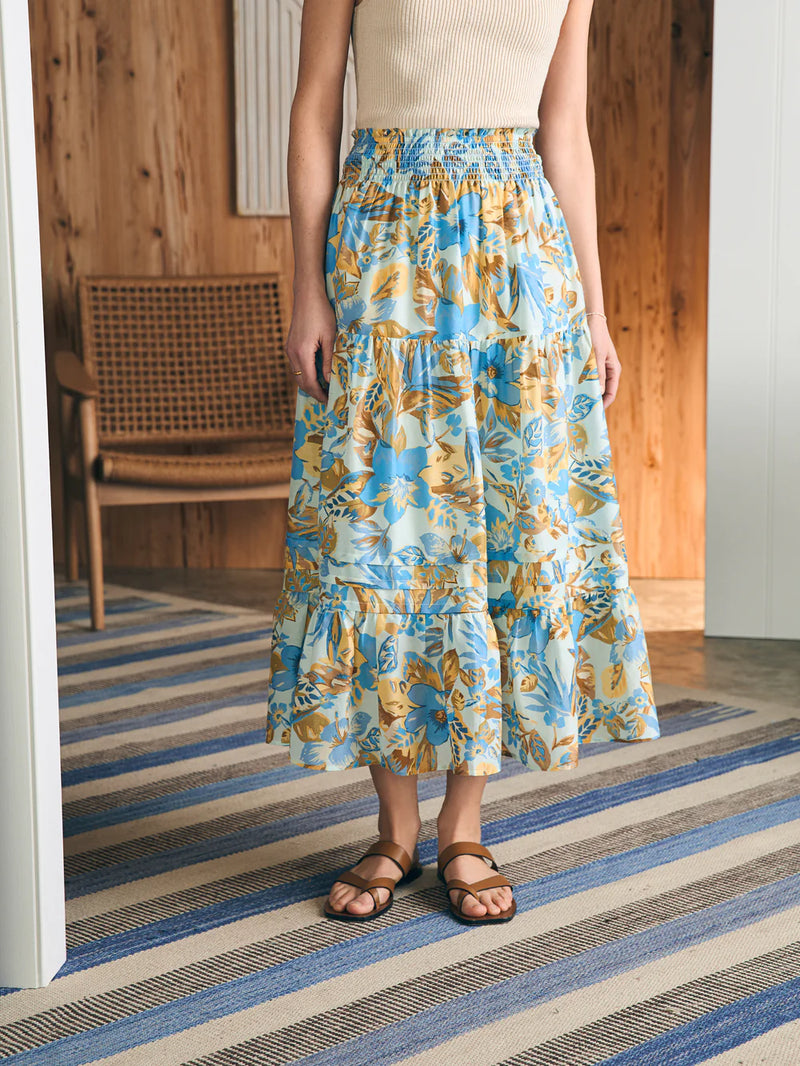 Woman wearing midi skirt in blue, yellow and khaki floral print