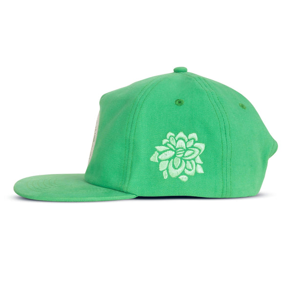 Green snapback hat with white circle patch on the front with a cactus waving and wearing a cowboy hat with script "reach for the sky Sendero Provisions Co." around it and a green flower embroidered on the side of the hat