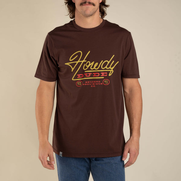 Brown short sleeve t-shirt with script "Howdy Dude Sendero Provisions Co. ESTD 2014" on the front in red and yellow writting