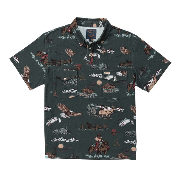Dark green short sleeve polo shirt with double breast pockets with cartoon images of cowboy on horse, fence, fish, mountains, elk, eagle, and sun all repeated throughout the shirt