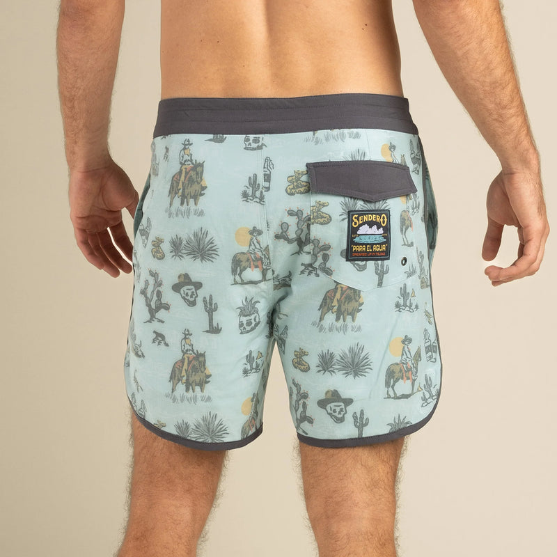 Men's board shorts with images of cartoon cowboy on horse, agave plant, alcohol. skulls, desert, scorpion and snakes all over