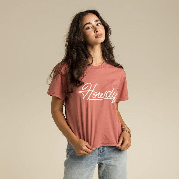 Cropped salmon color short sleeve t-shirt with "Howdy" written in white across the chest