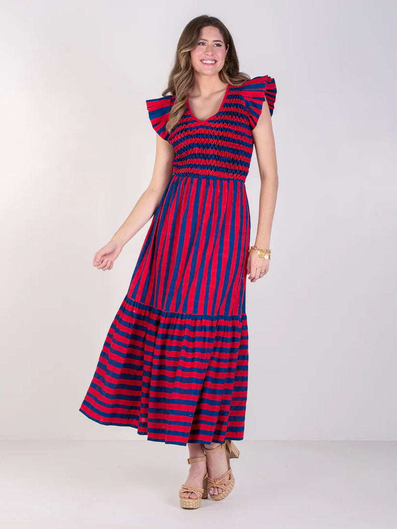 Woman wearing a red and blue striped dress on a white background