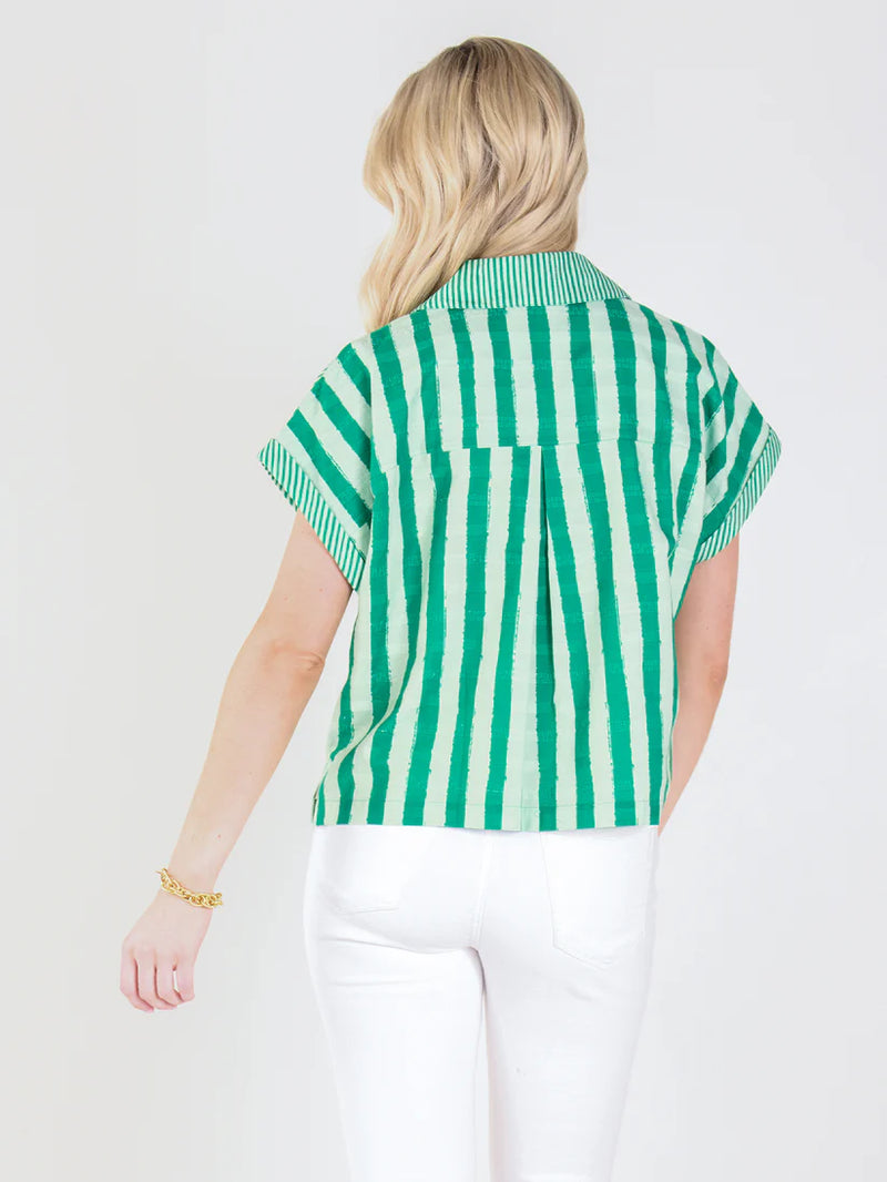 Person wearing a green and white striped shirt on a white background
