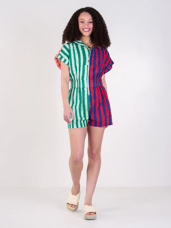 Woman wearing a colorful striped romper on a white background