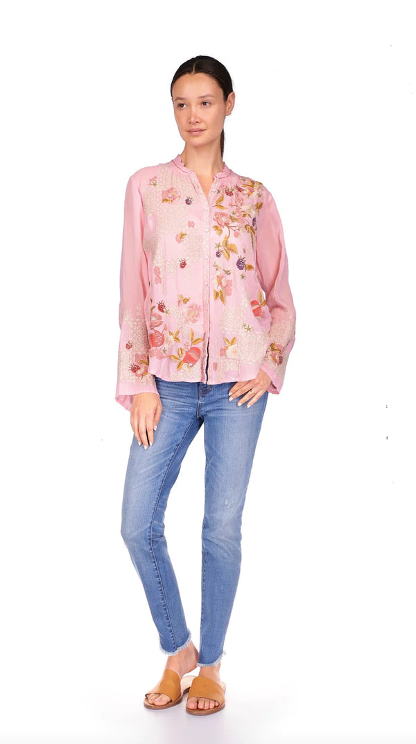 WOMAN WEARING PINK BUTTON UP BLOUSE WITH MULTICOLOR FLOWER EMBROIDERED THROUGHOUT 