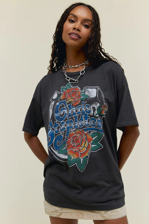 Woman wearing grey short sleeve tee with graphic of horse shoe with roses and script "Christ Stapleton" in the center