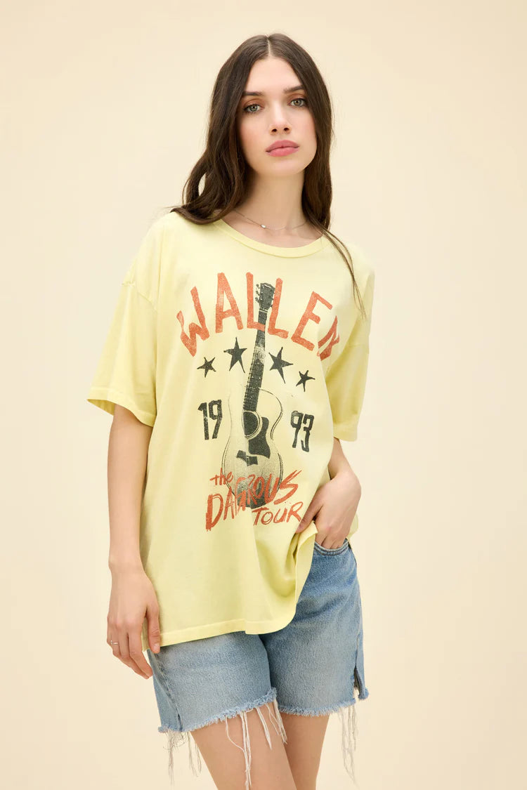 Woman wearing yellow oversize tee with guitar on front and "Wallen the Dangerous Tour 1993" on the front