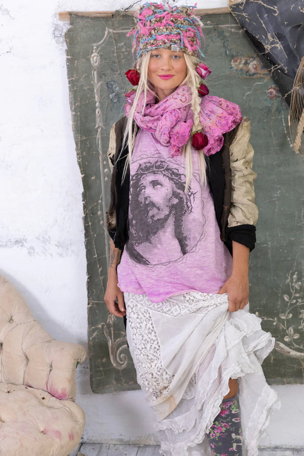 Woman wearing a distressed purple tee with the face of Jesus on the front