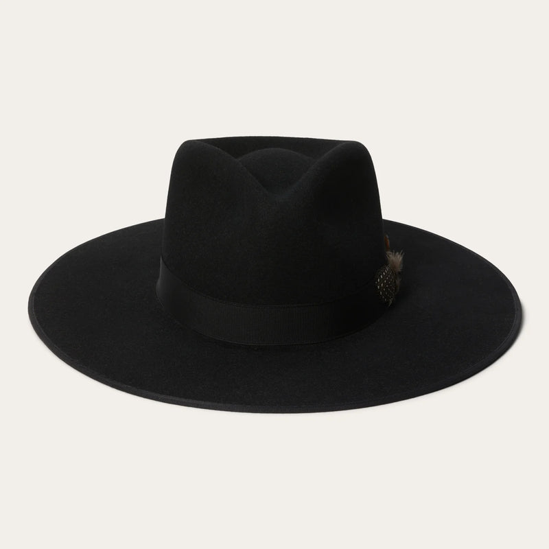 Black fedora hat with a feather on a light gray background