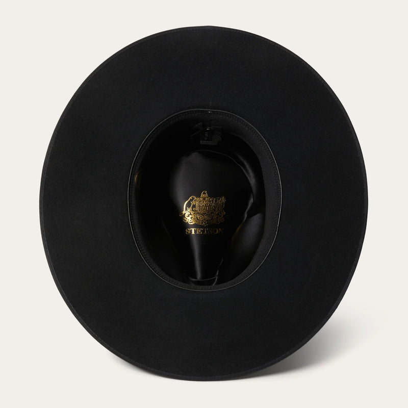 Black hat with a brand logo on a light gray background