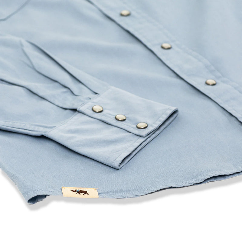 Light blue shirt with button details on a white background