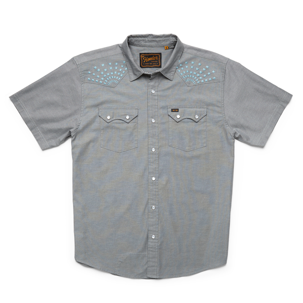 Grey short sleeve pearl snap shirt with double breast button pockets with embroidered blue square sunbeams near the shoulders
