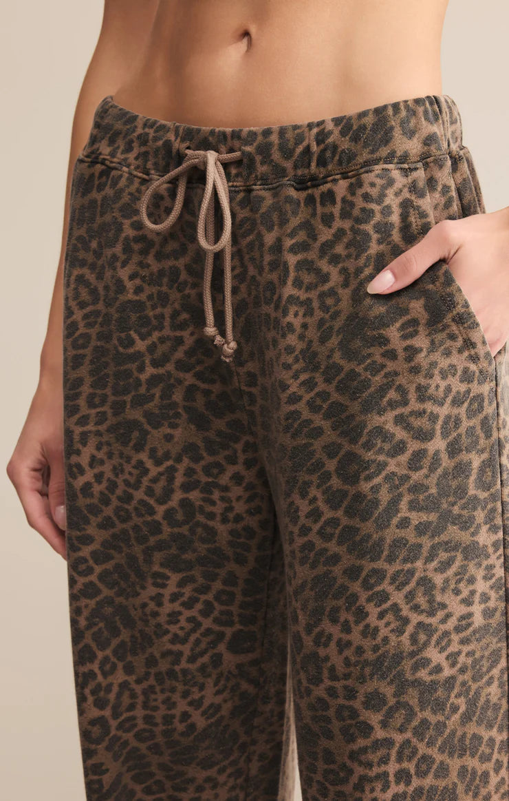 Leopard print pants with a drawstring waistband on a neutral background