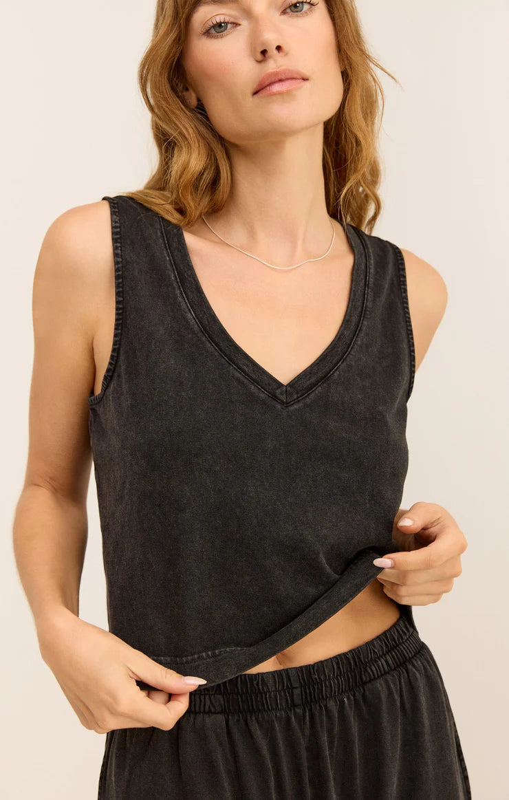 Woman wearing black v-neck tank top with crop cut