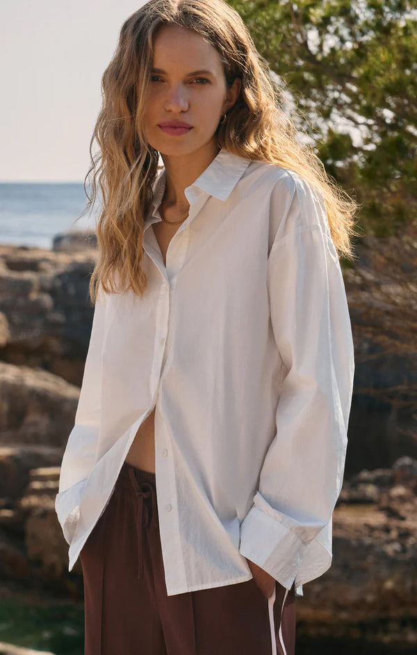 Woman wearing a white shirt with a blurred natural background