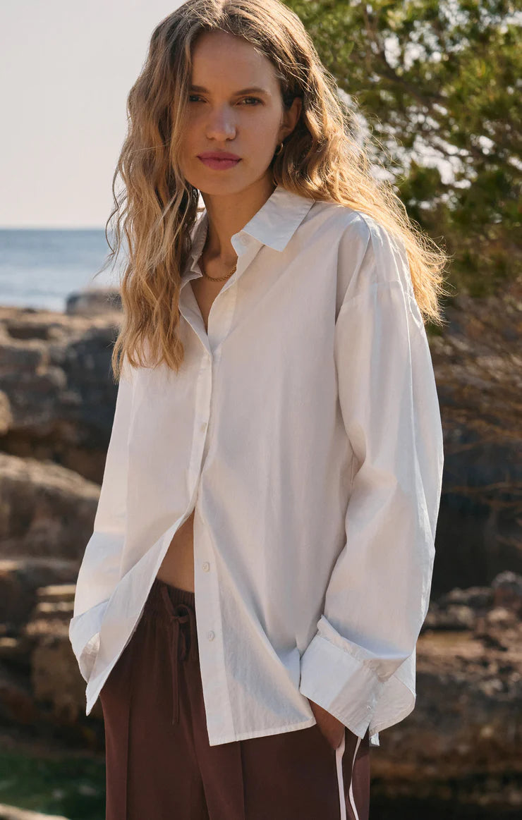Woman wearing a white shirt with a blurred natural background