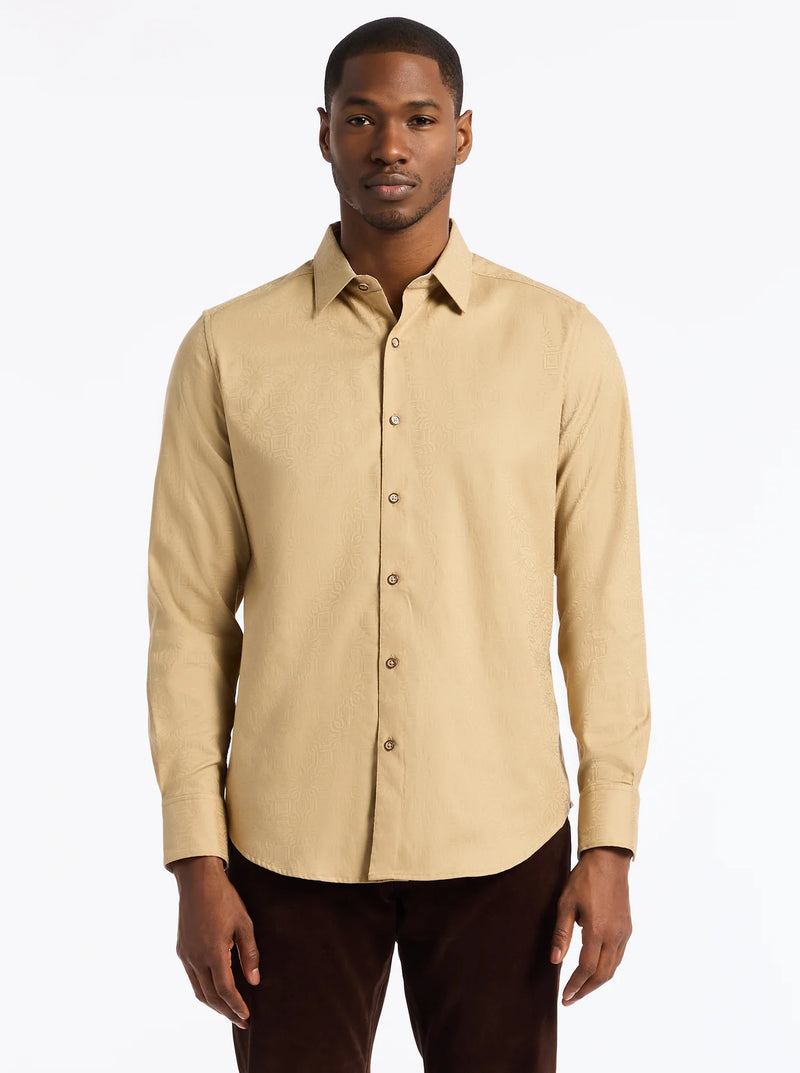 Man wearing a beige button-up shirt against a white background