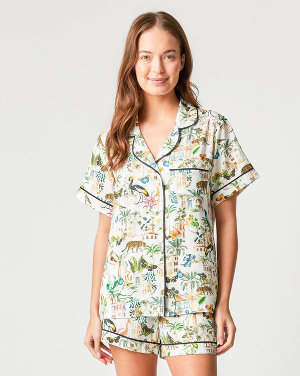 Woman wearing pj set with variety of animals all over 