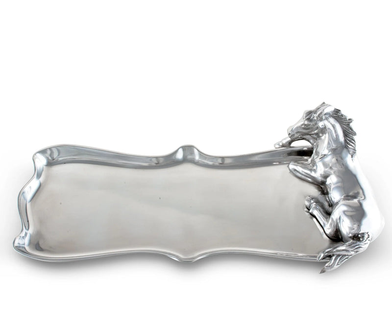 Silver platter with horse body laying down at the side of it