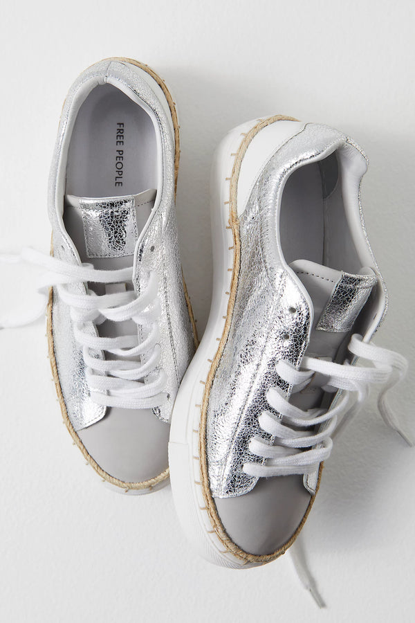 Women's metallic silver sneaker with espadrille-inspired stitching.