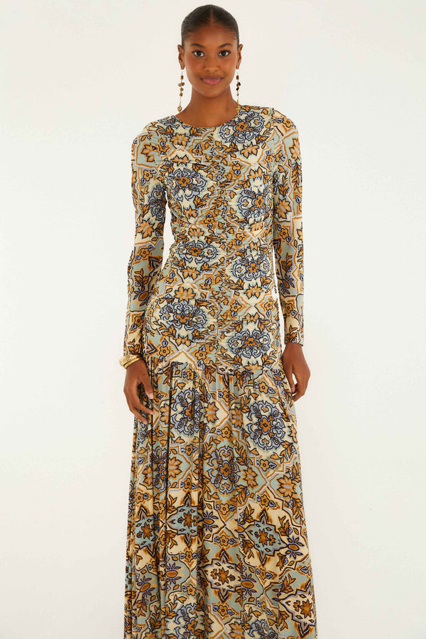 Woman wearing a long floral dress on a white background