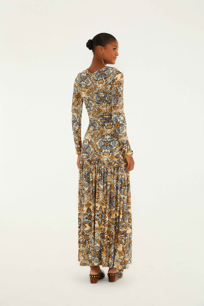 Woman wearing a long floral dress on a white background