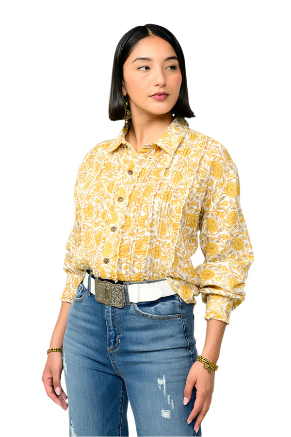 Woman wearing a yellow floral blouse and blue jeans on a white background