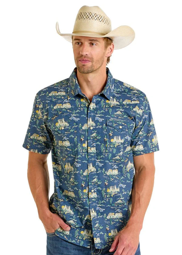 Man wearing a blue patterned shirt and cowboy hat on a white background