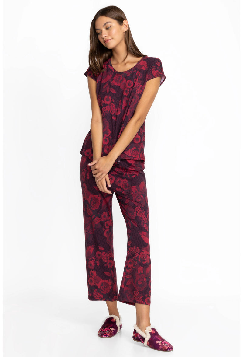 Woman wearing maroon pjs with floral pattern throughout