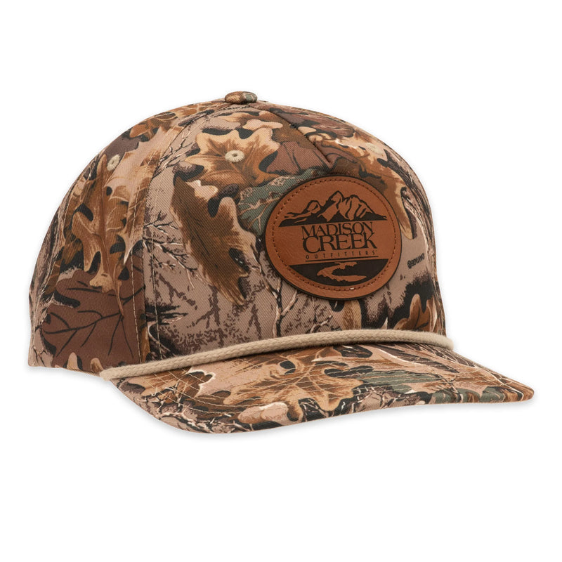 Camouflage baseball cap with a leather patch on a white background