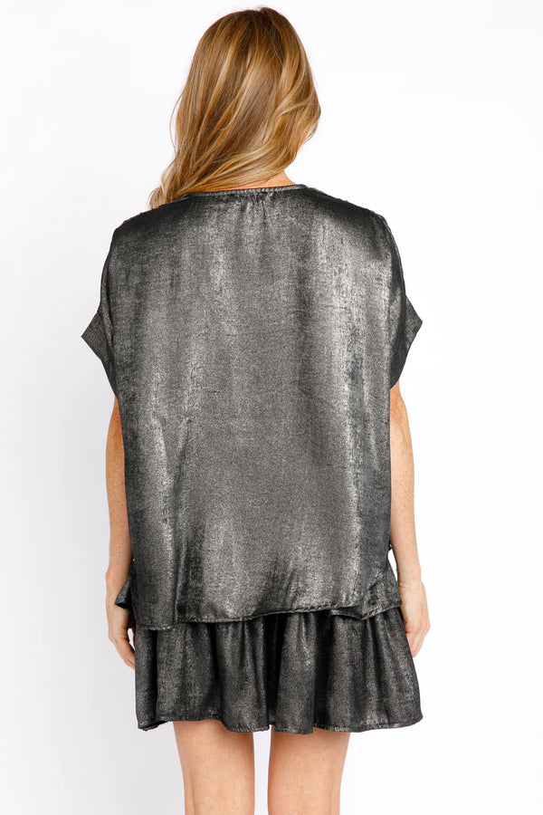 Woman wearing metallic grey shirt with short sleeves and v neck
